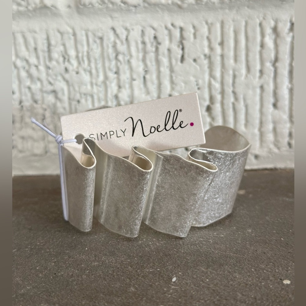 New Simply Noelle silver color ribbon cuff bracelet. Moldable to wrist. Fall 24
